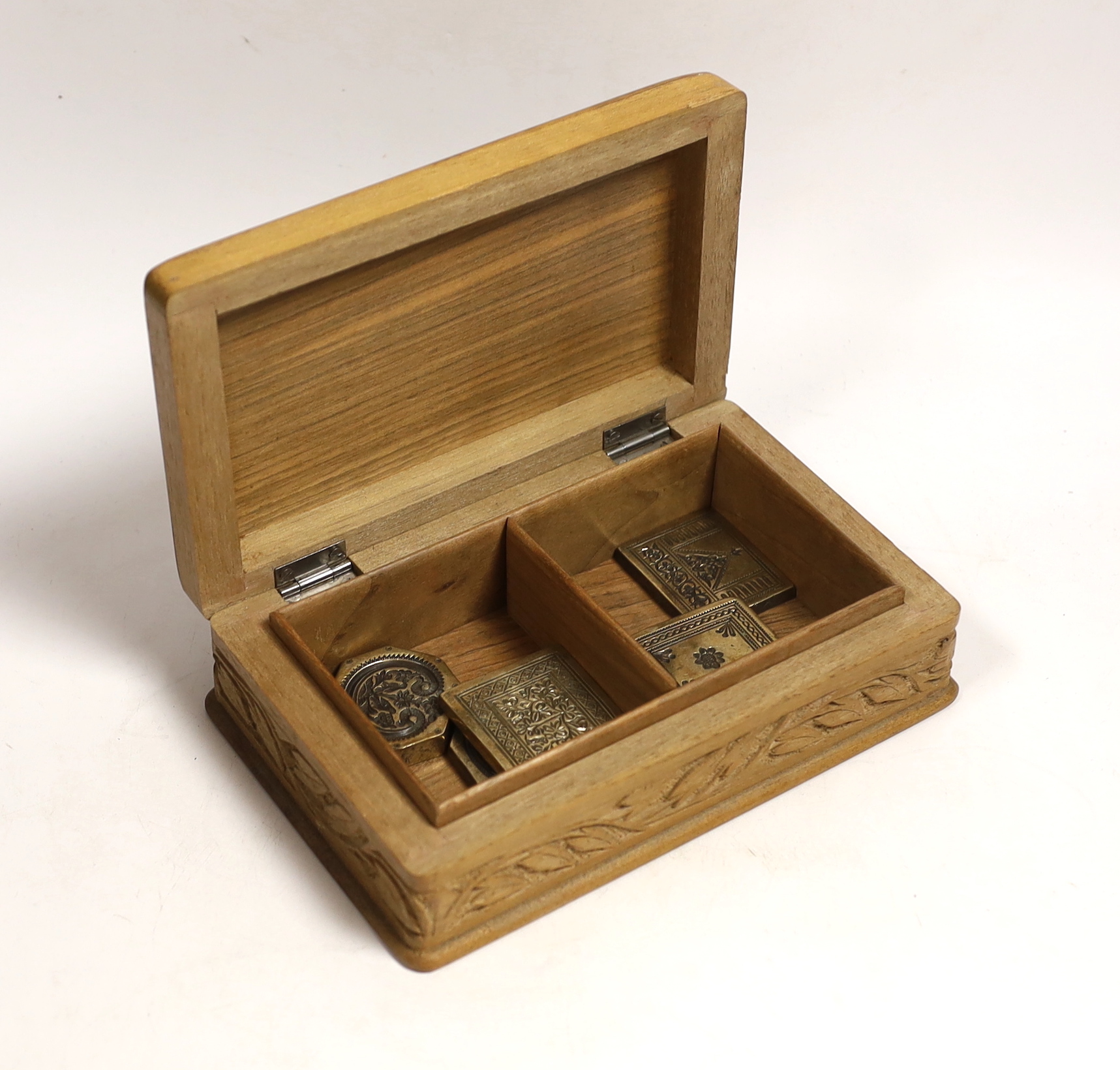 A group of Indian bronze sweet moulds, contained in a carved teak box